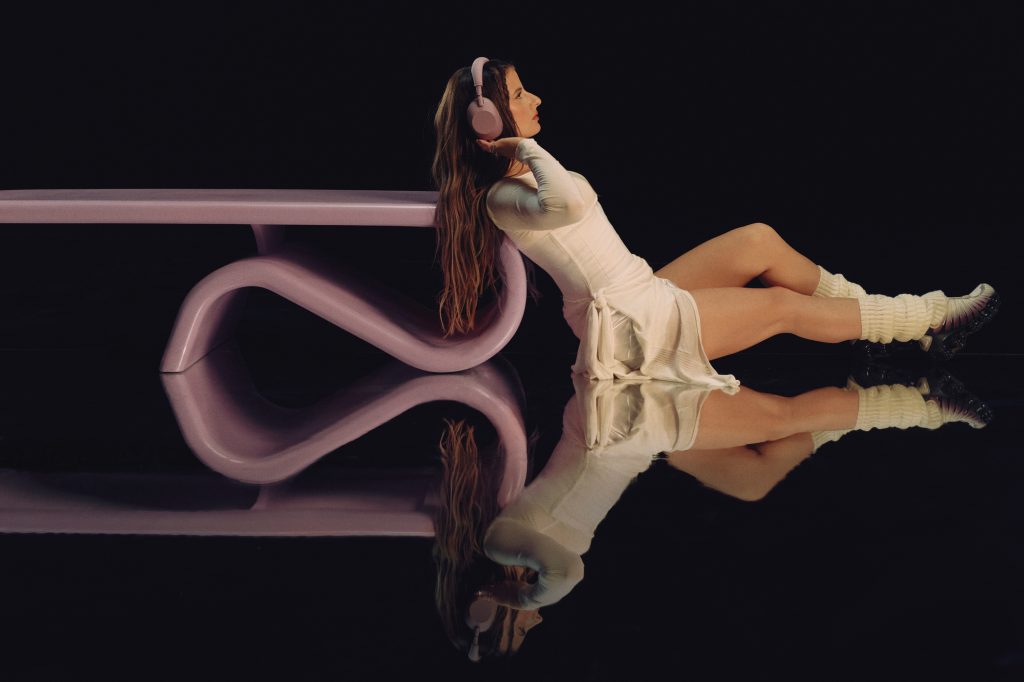 A woman sitting on a table with headphones on