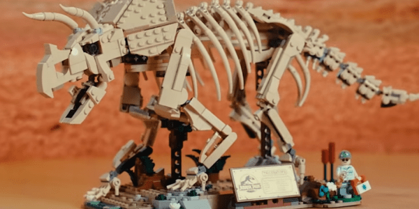 A toy dinosaur with a sign