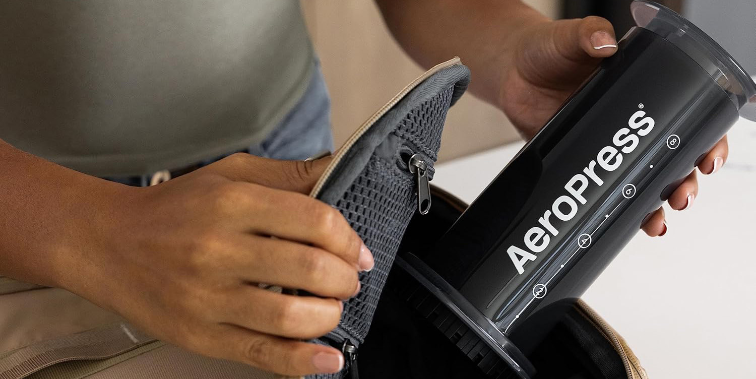 A person holding a grey bag