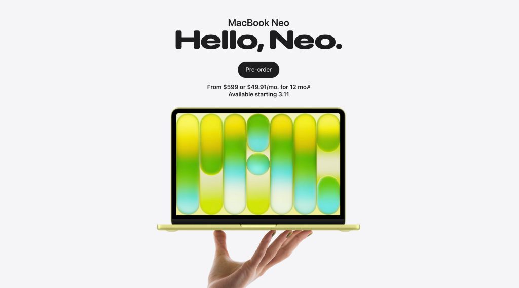 A hand holding a laptop