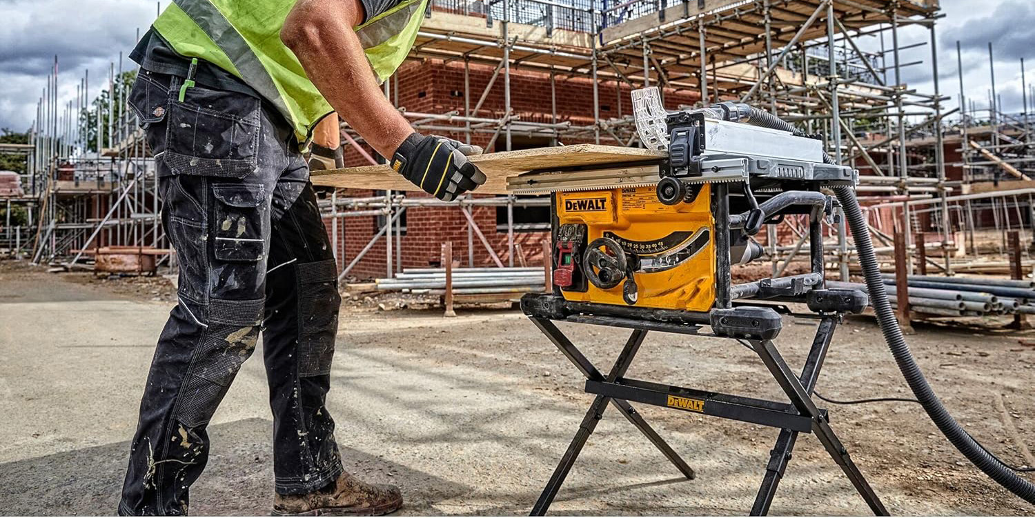 A man in safety gear holding a piece of wood