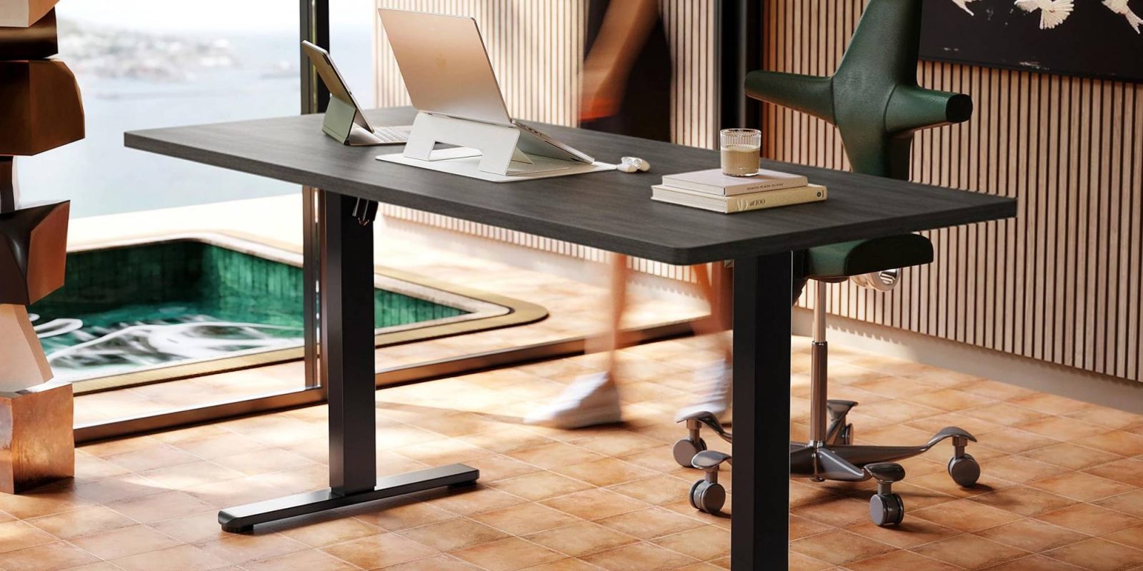 A desk with a laptop and a book on it