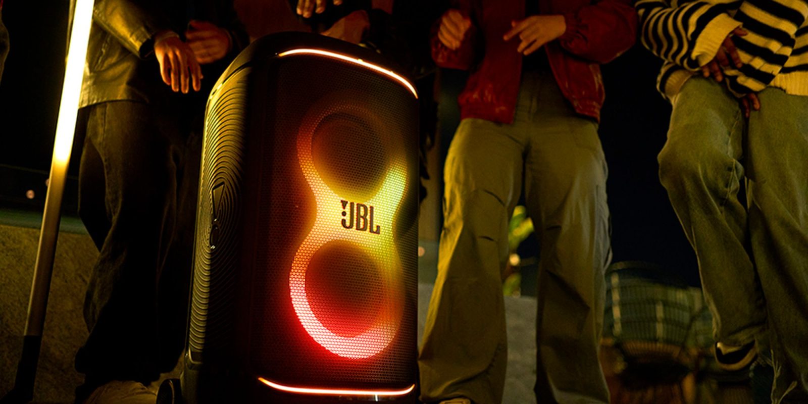 A person standing next to a large speaker
