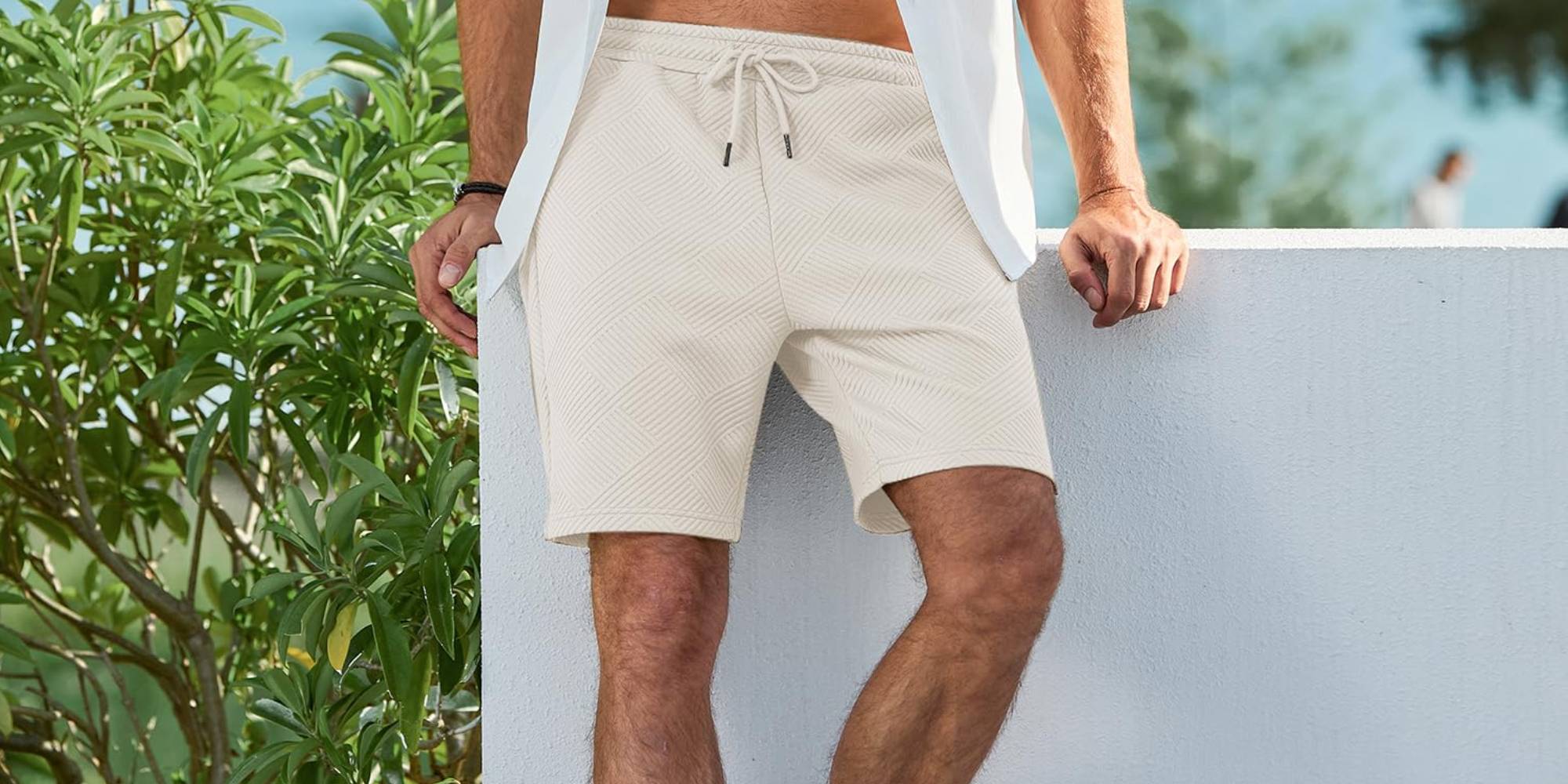 A man wearing shorts and a white shirt