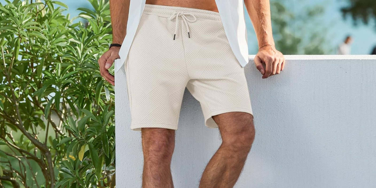 A man wearing shorts and a white shirt