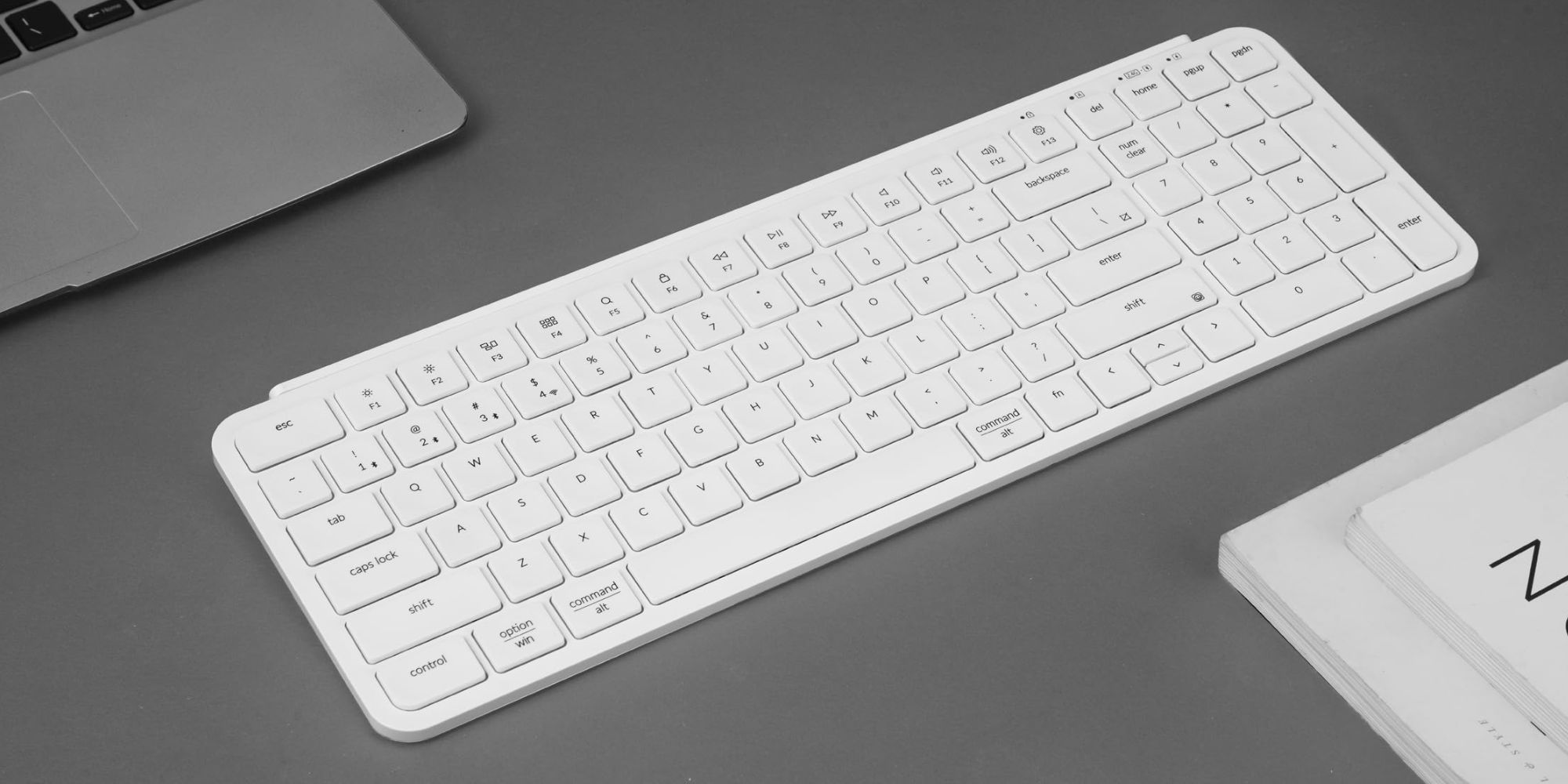 A white keyboard on a gray surface.