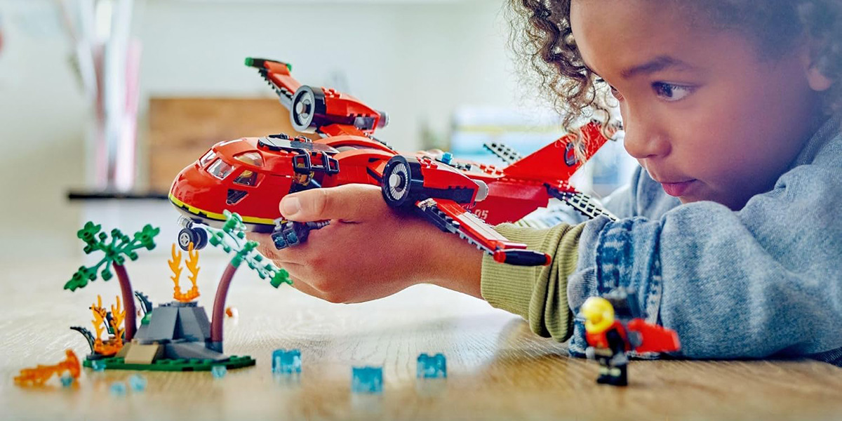 A child playing with a toy plane