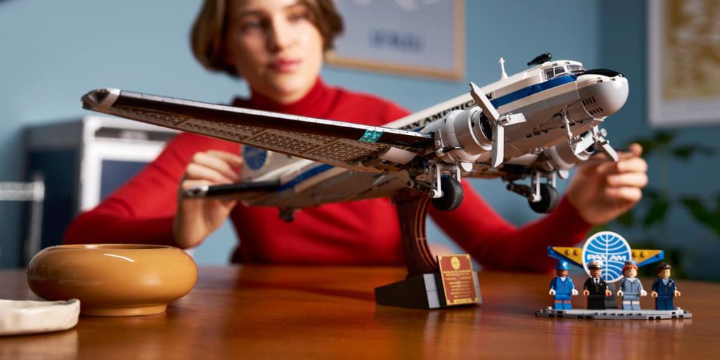 A woman sitting at a table with a model airplane LEGO April 2026 