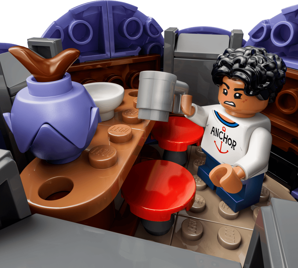 A lego man holding a mug