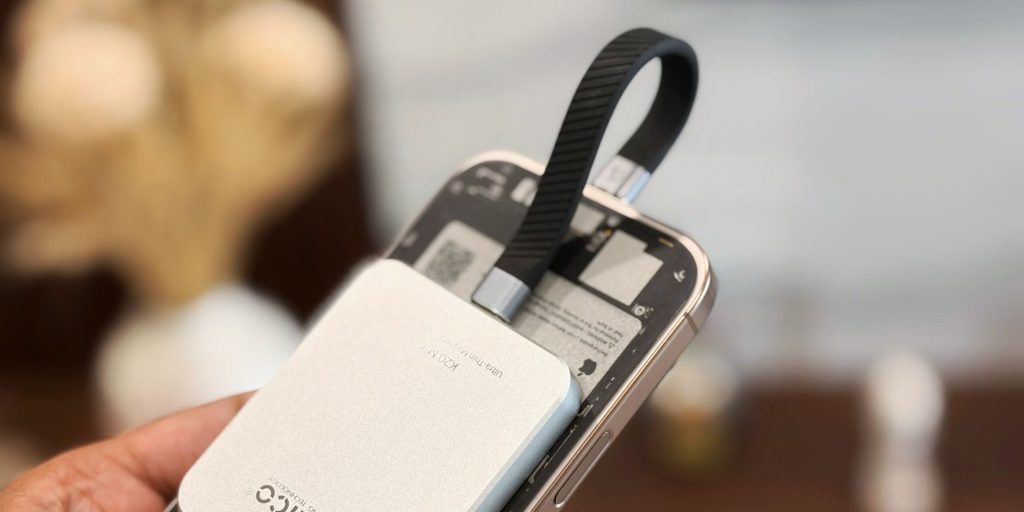 A cell phone with a strap attached to it