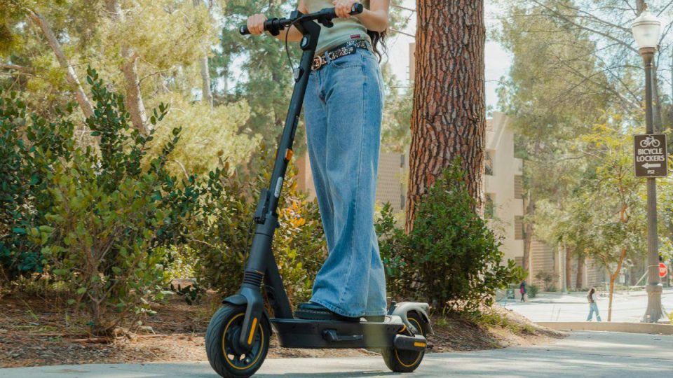 A woman riding a scooter