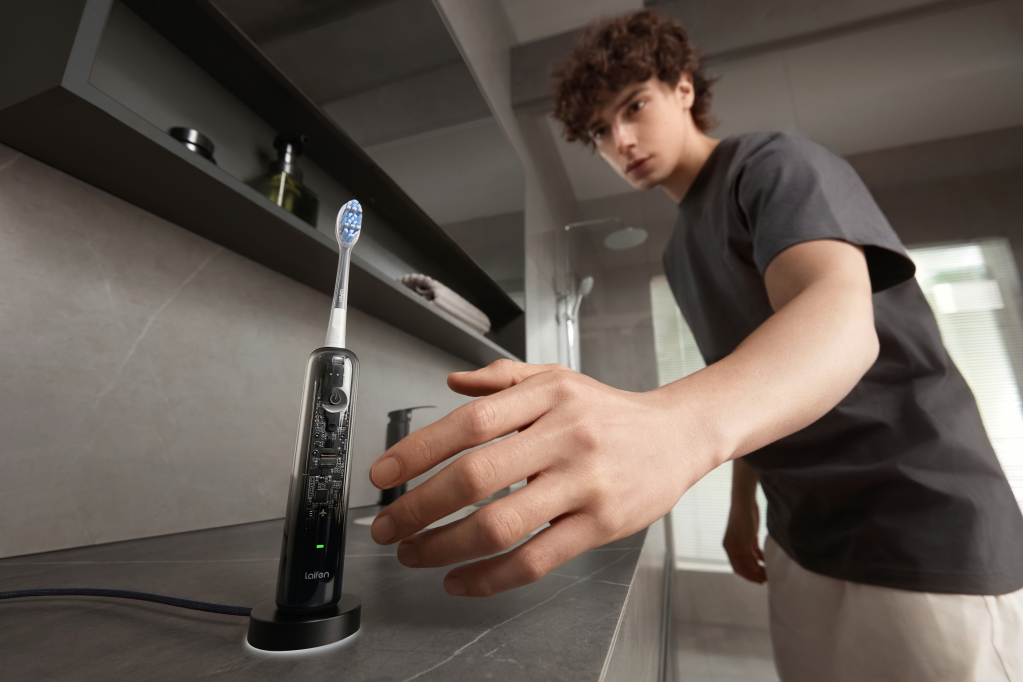A man touching a toothbrush