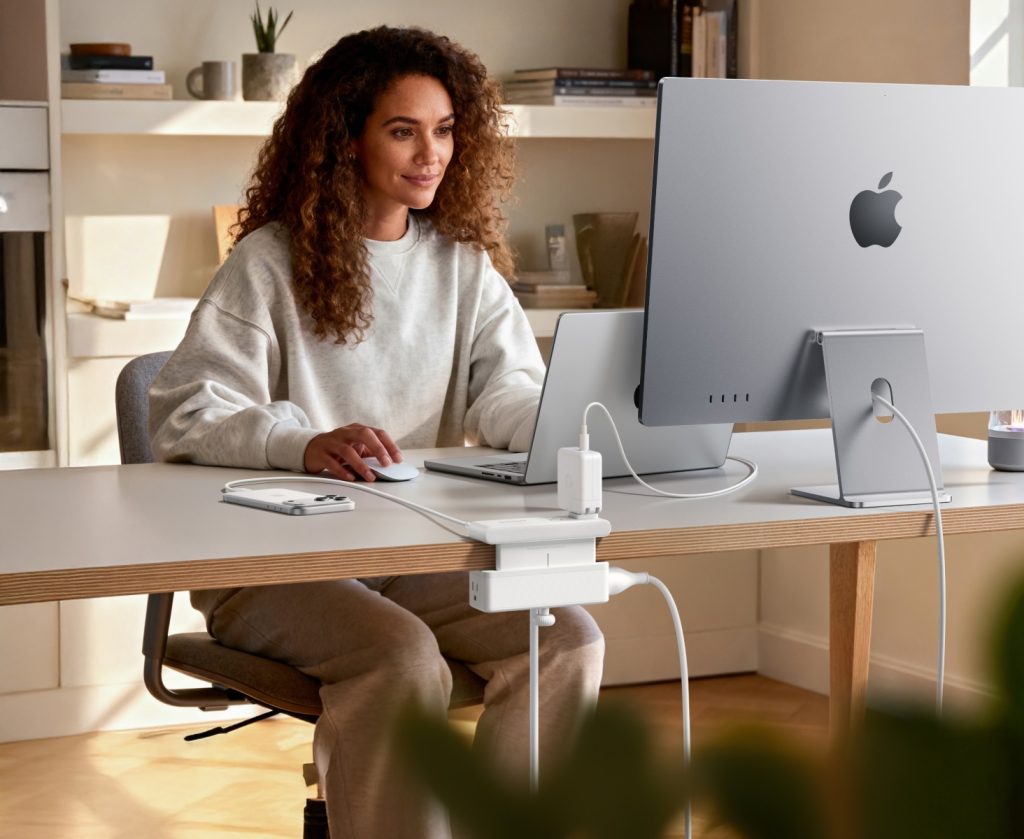 A woman sitting at a desk with a computer