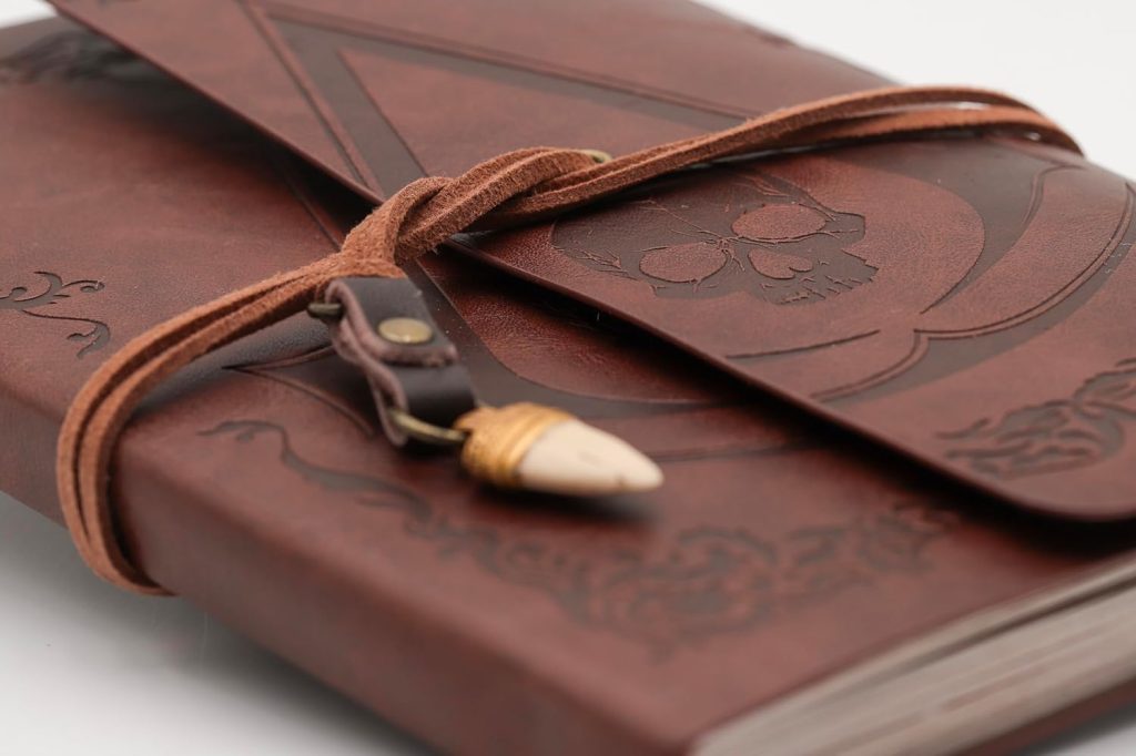 A leather bound book with a leather strap