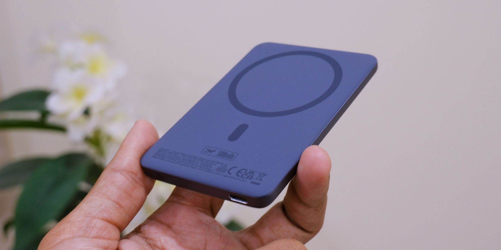 A hand holding a device