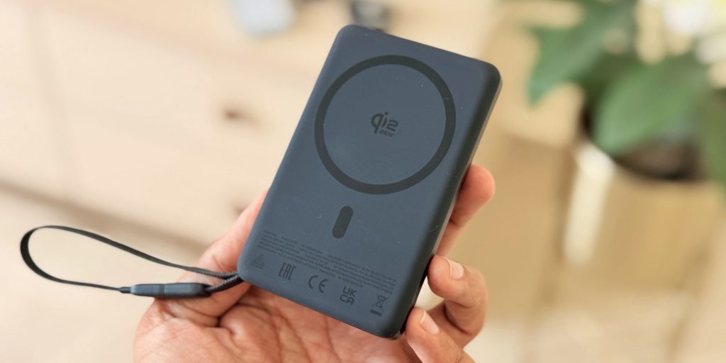 A hand holding a black device