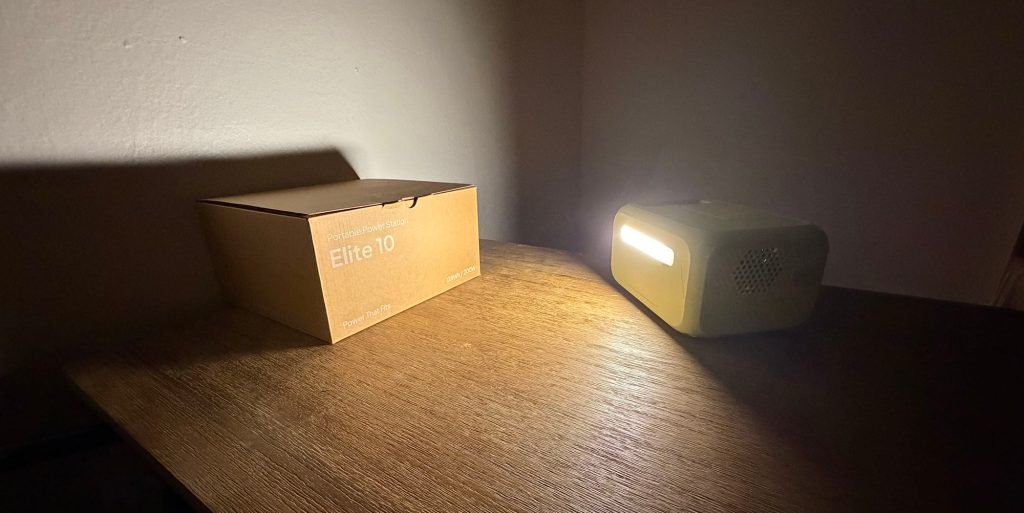 A box and a Elite 10 Mini on a table in the dark