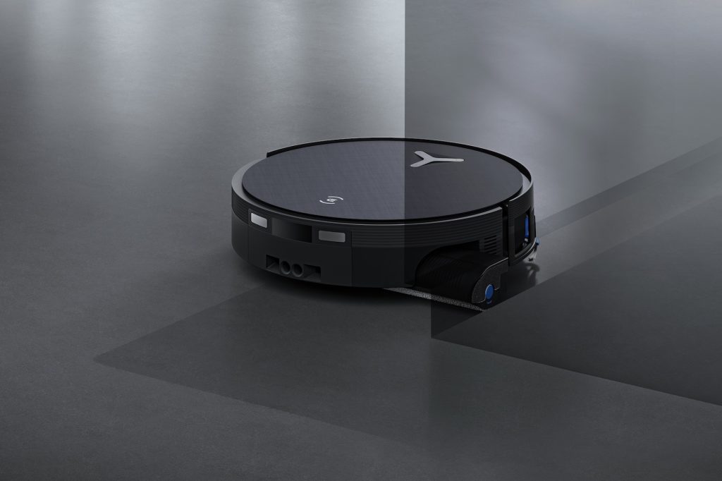 A black robot on a grey floor