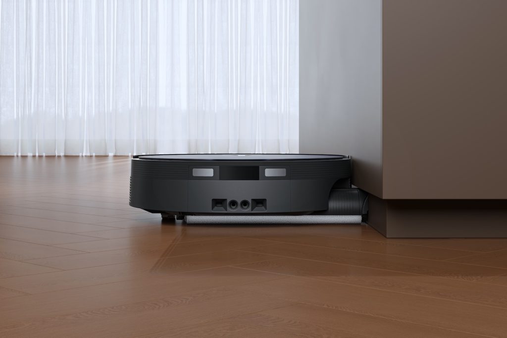 A robotic vacuum cleaner on a wood floor