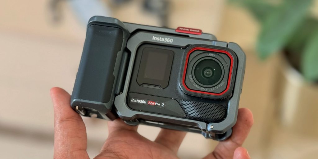 A hand holding a camera