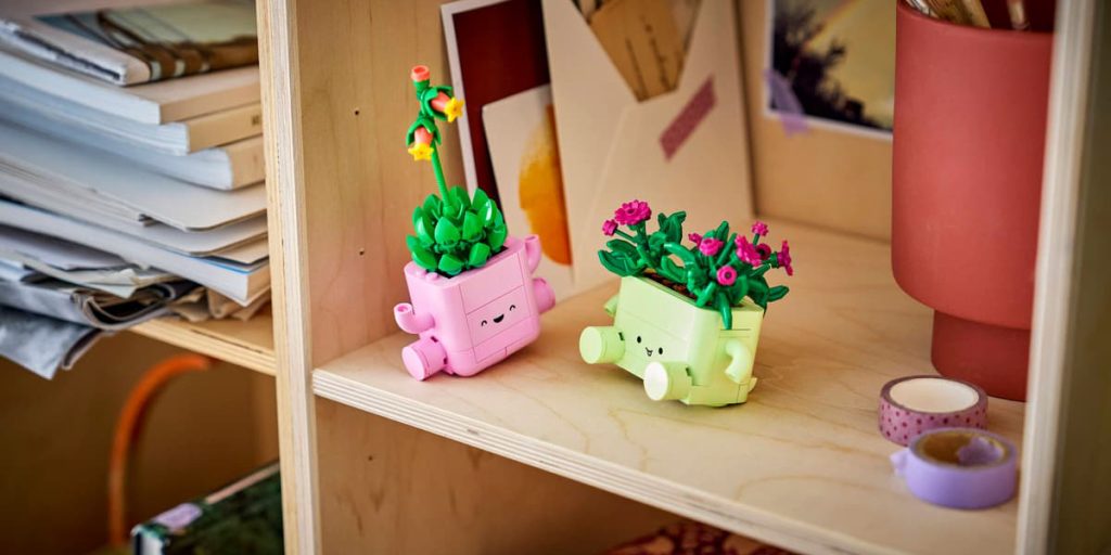 A couple of small plastic planters on a shelf