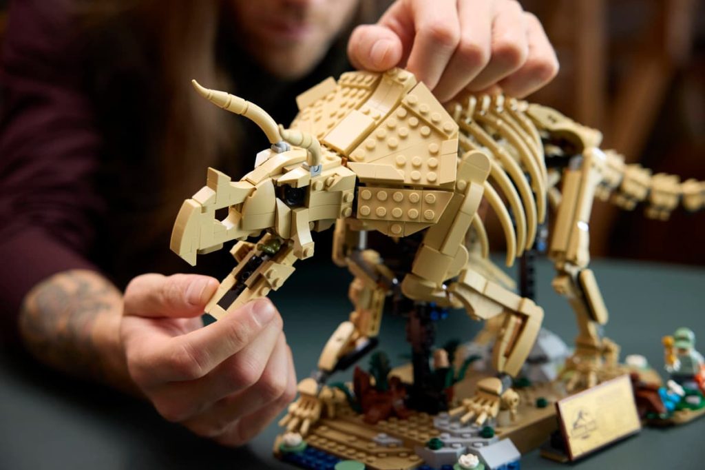 A person holding a toy dinosaur