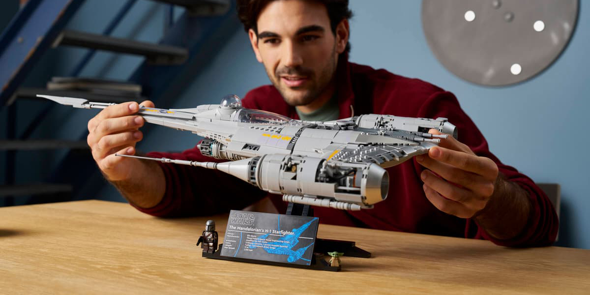 A man holding a model of a spaceship