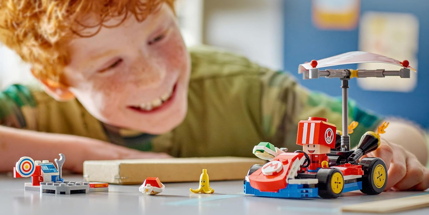 A boy looking at a toy