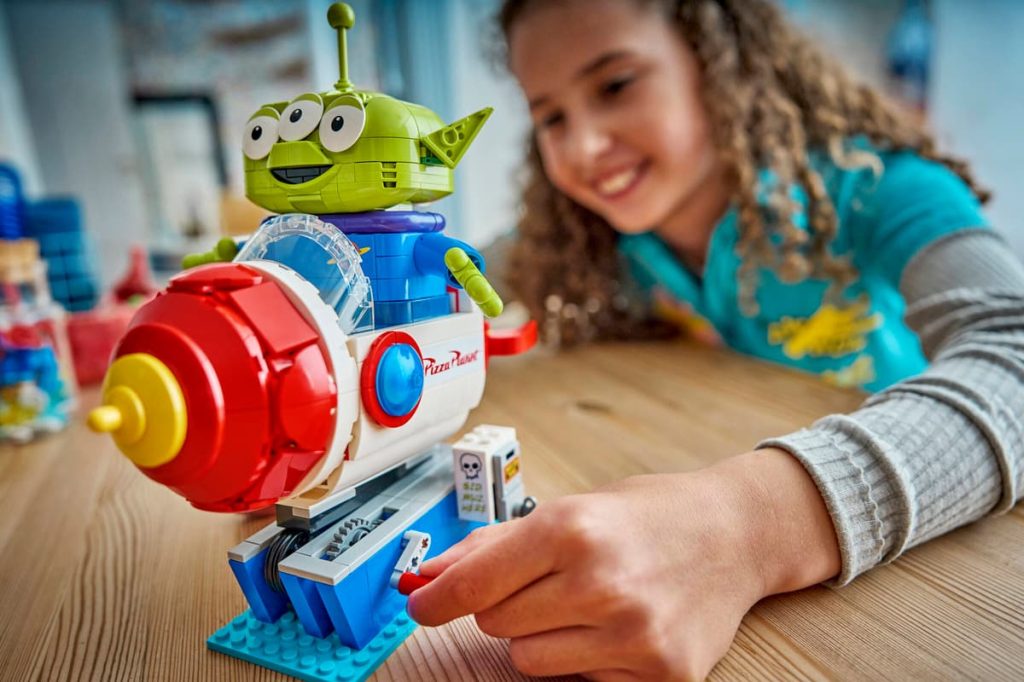 A child playing with a LEGO Toy Story set