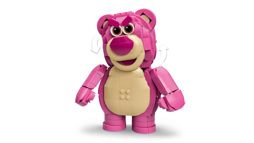 A pink toy bear with white arrows