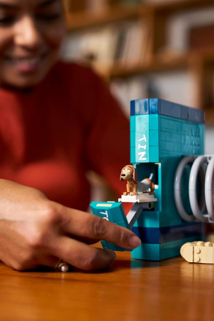 A person playing with LEGO Toy Story