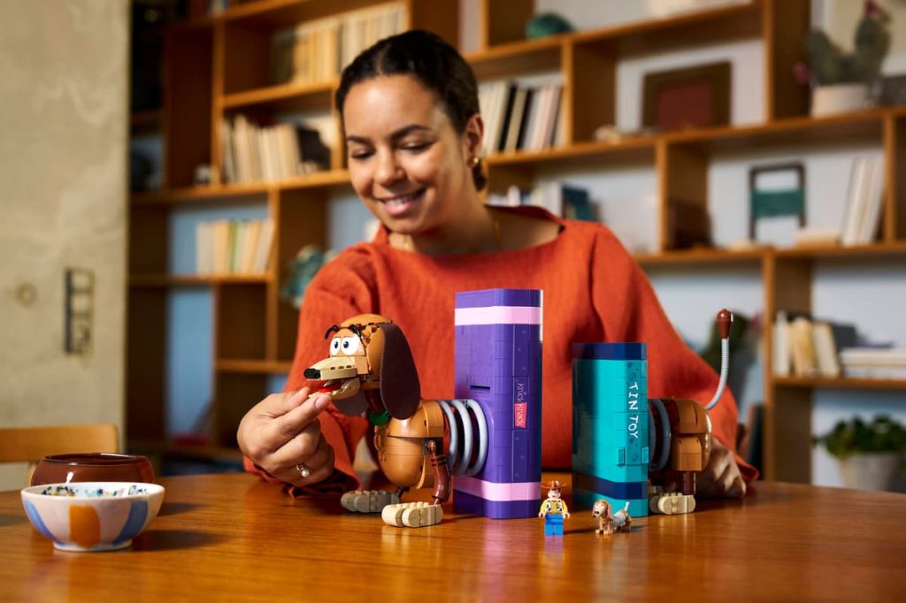 A woman playing with LEGO Toy Story set