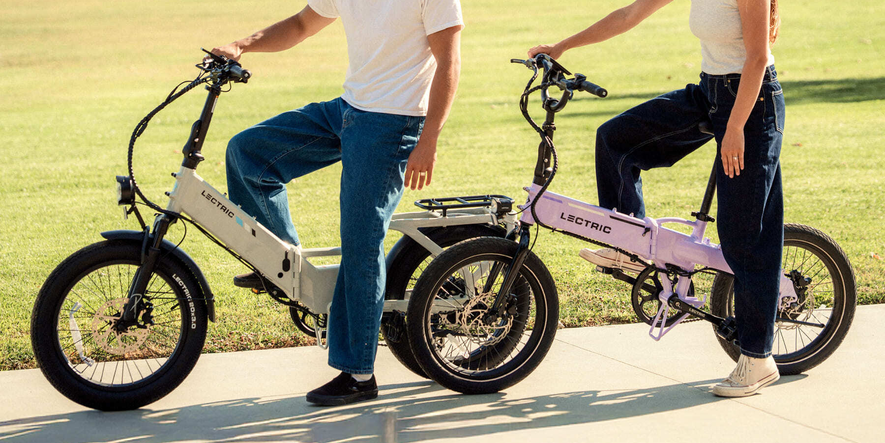 A man on a bicycle next to another man