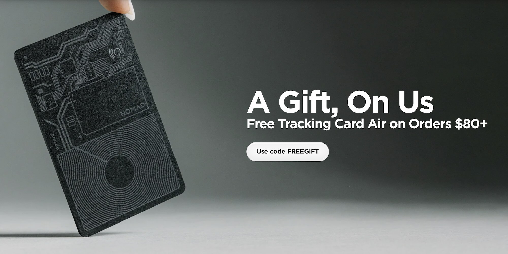 A hand holding a black rectangular object