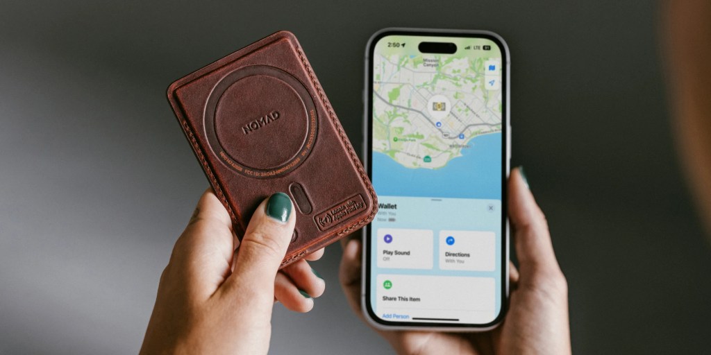 A person holding a phone and a device