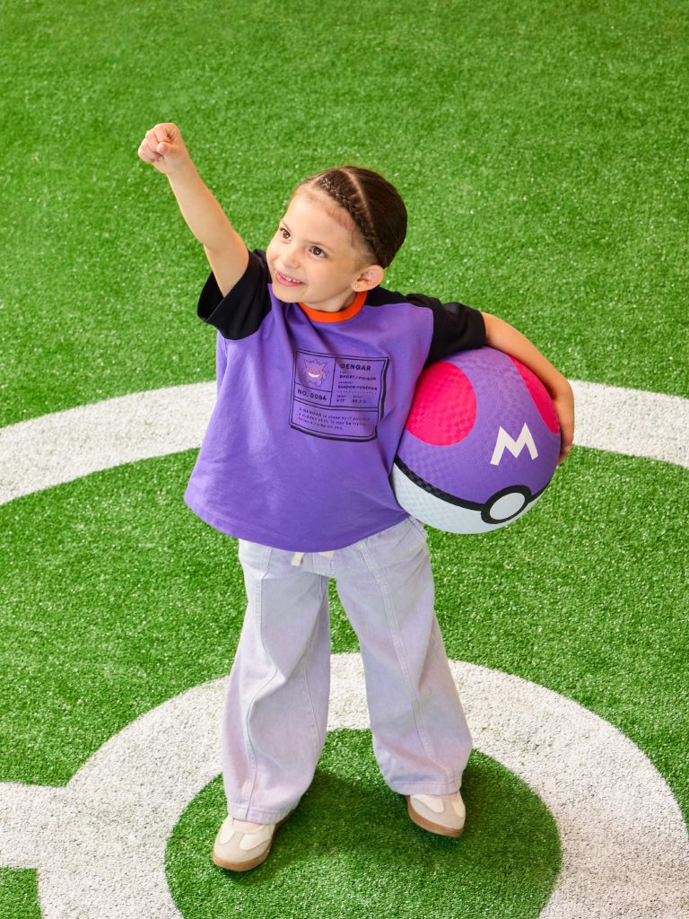 A girl holding a ball on a field