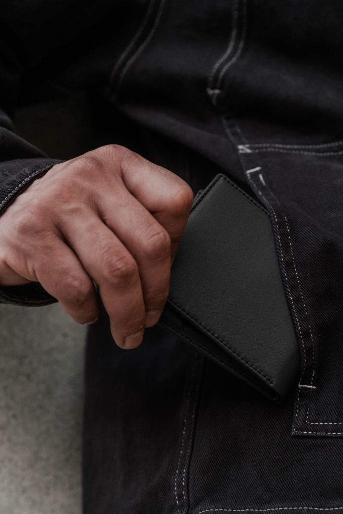 A hand holding a wallet