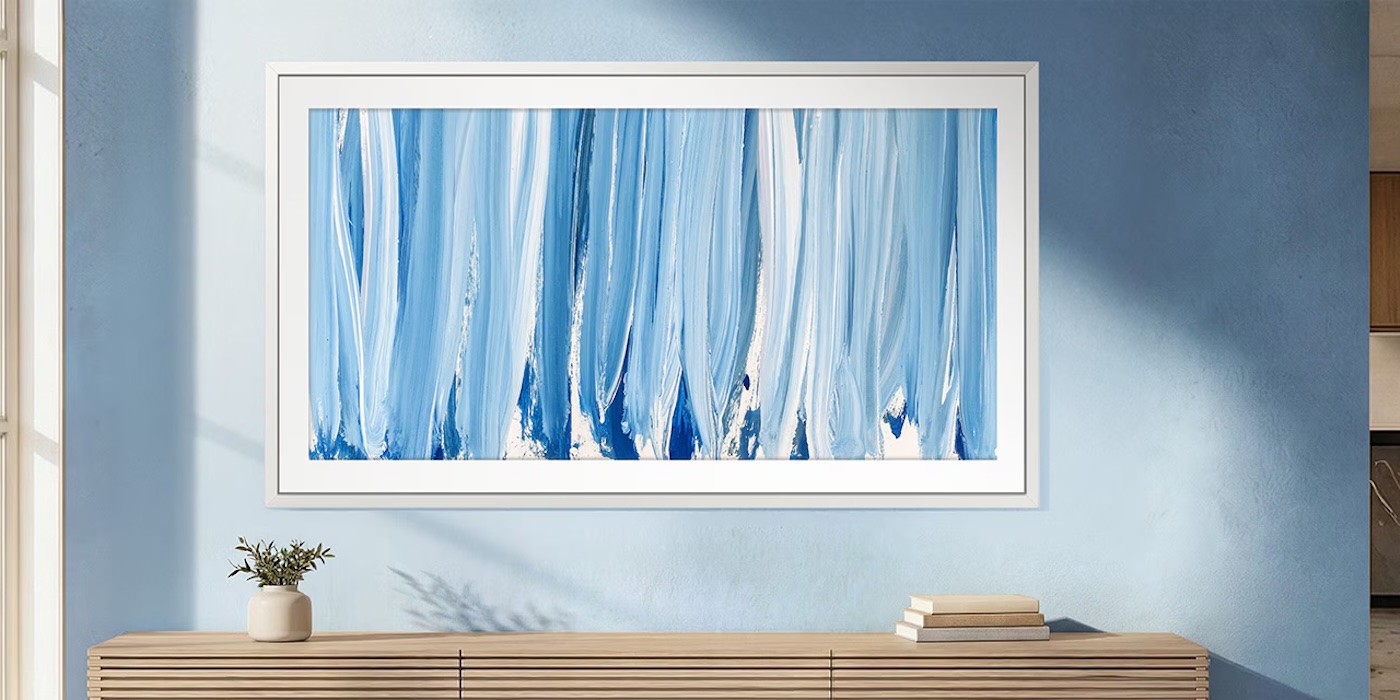 A white frame with blue and white art on the wall