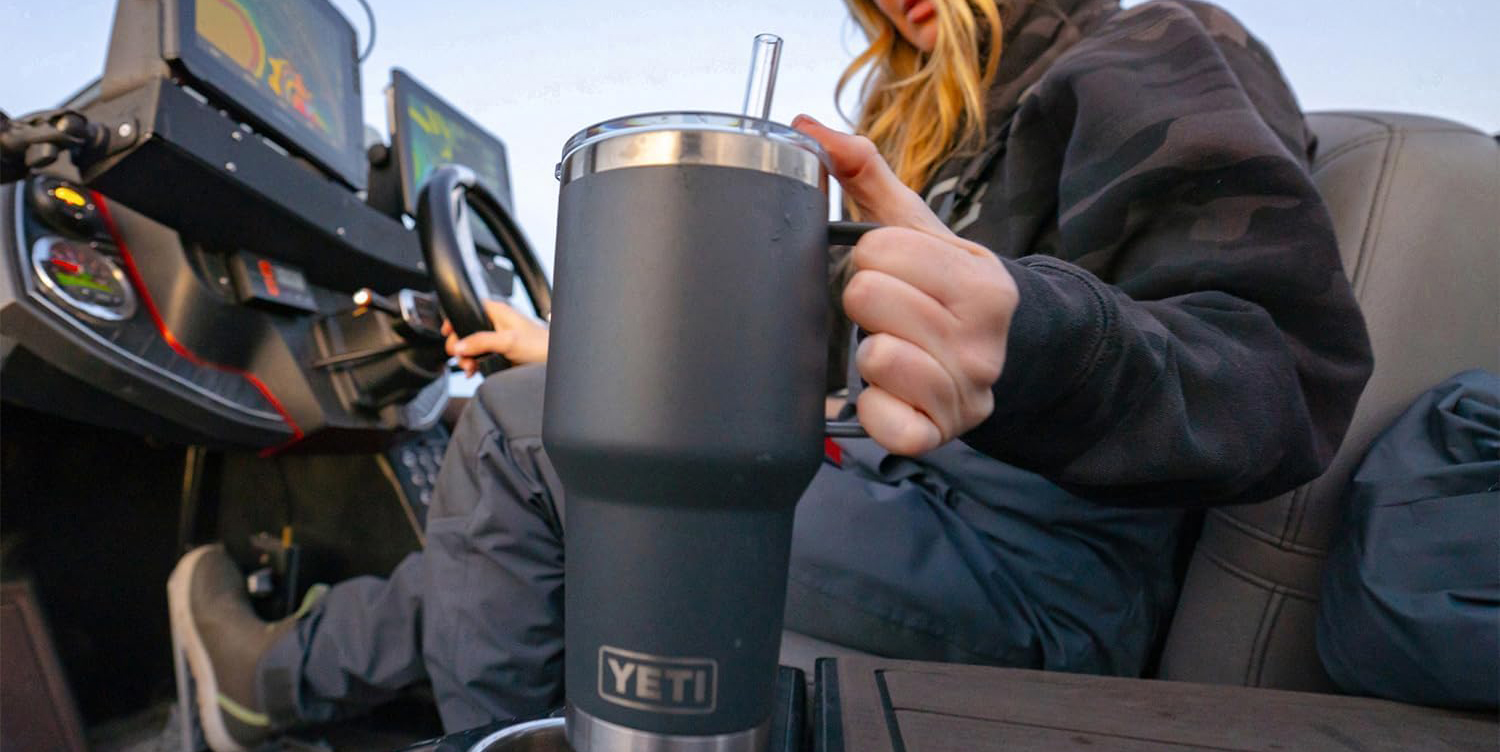 A woman holding a black mug