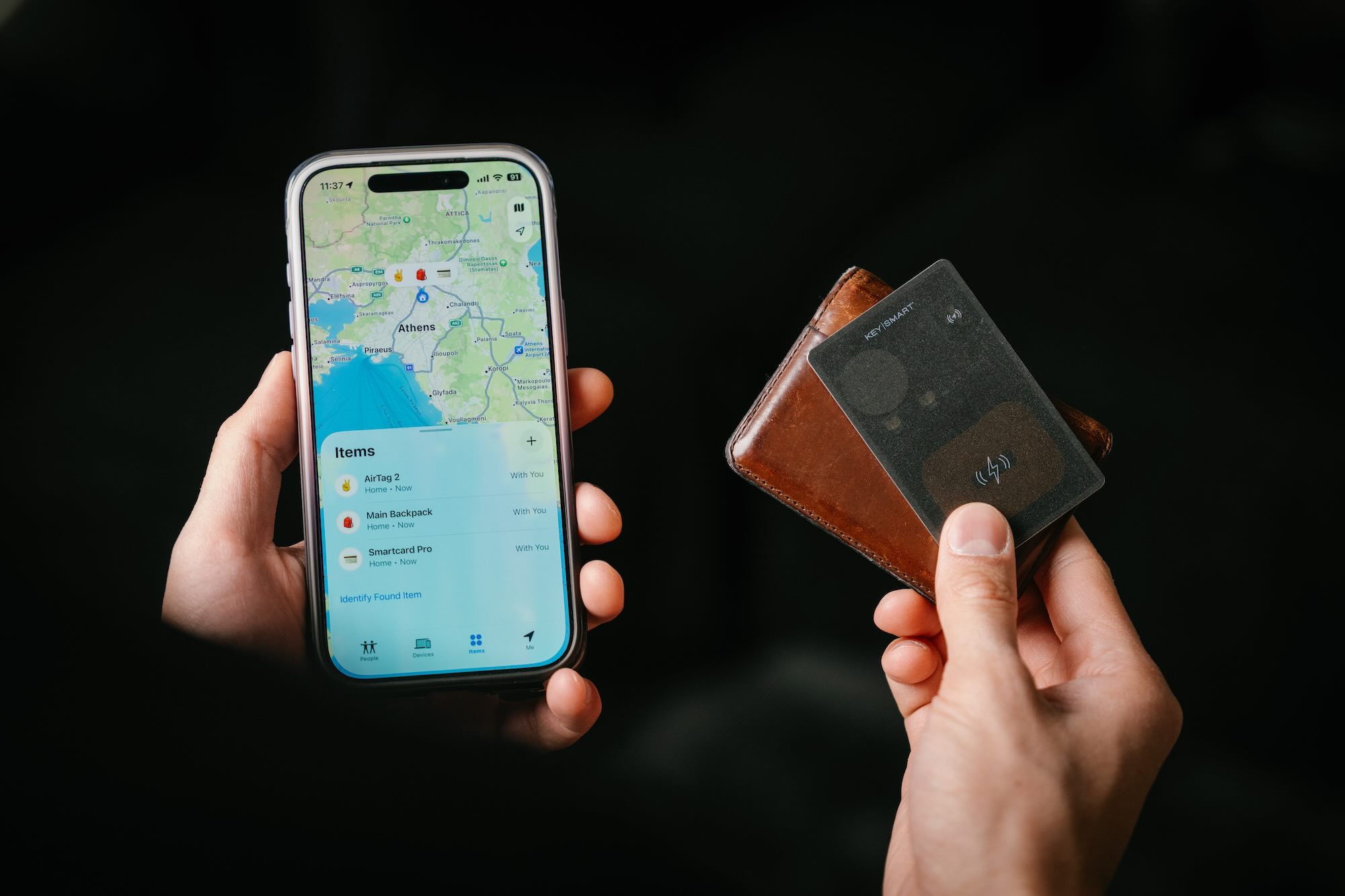 A hand holding a phone and a wallet