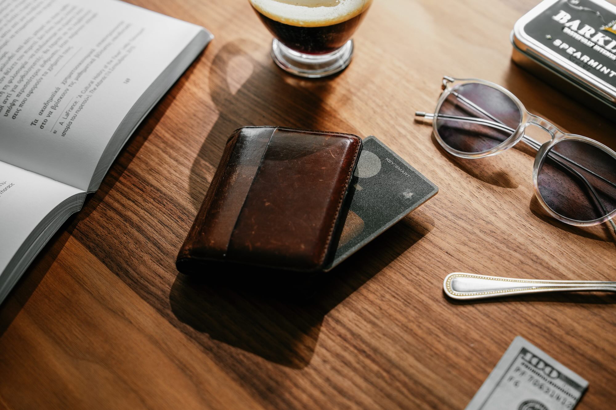 A wallet and sunglasses on a table