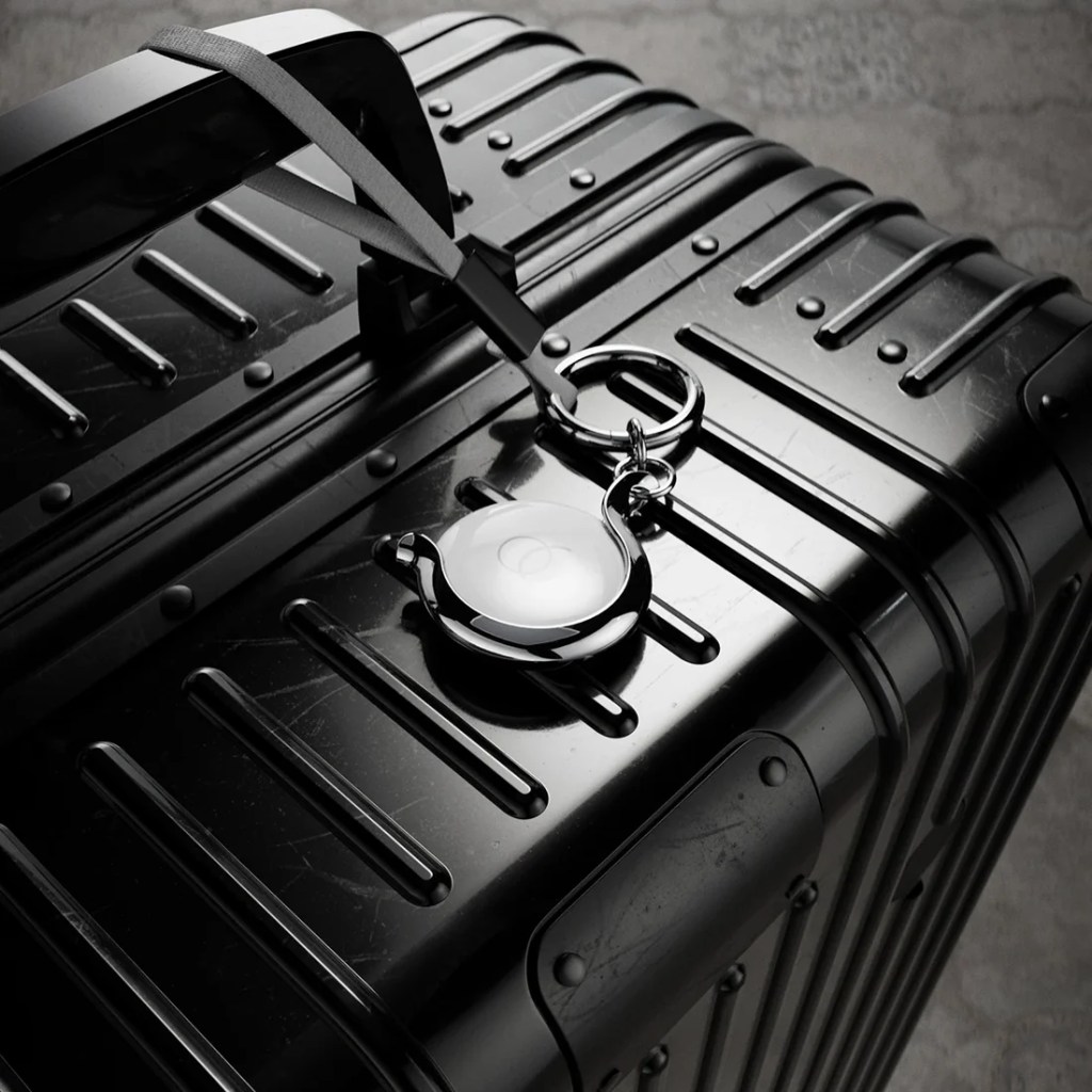 A black suitcase with a key chain