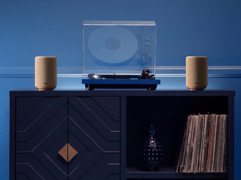 A record player and speakers on a shelf