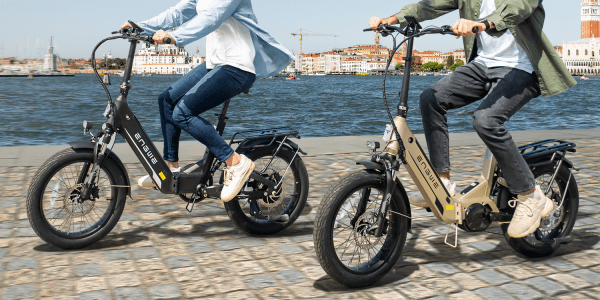 A man and woman riding electric bikes