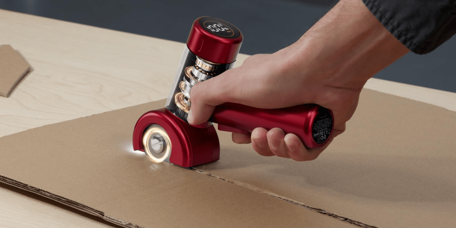 A hand holding a red device