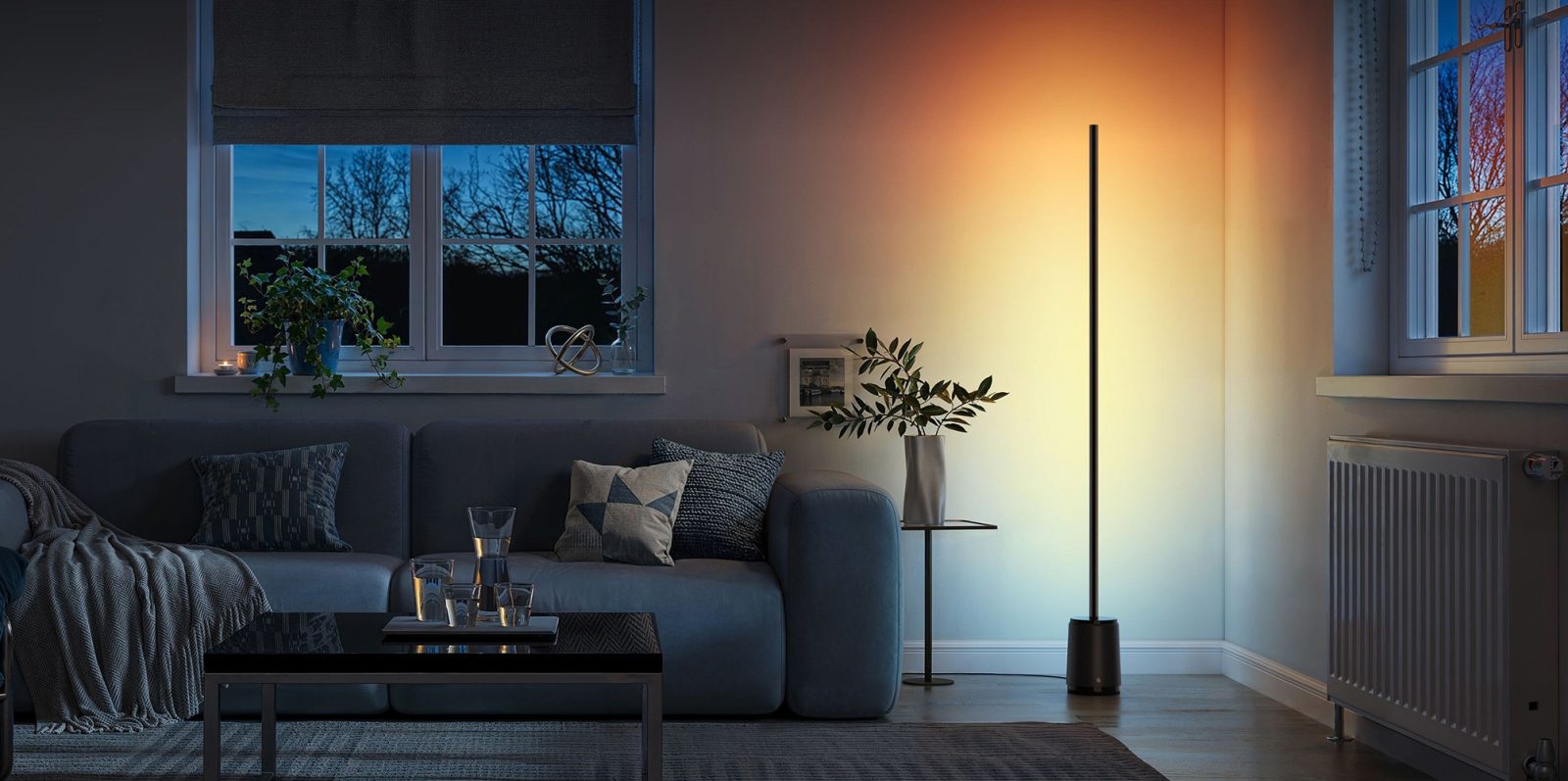 A living room with a couch and a lamp