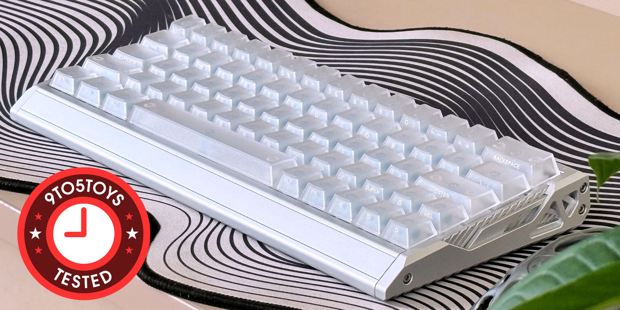 A white keyboard on a black and white striped surface