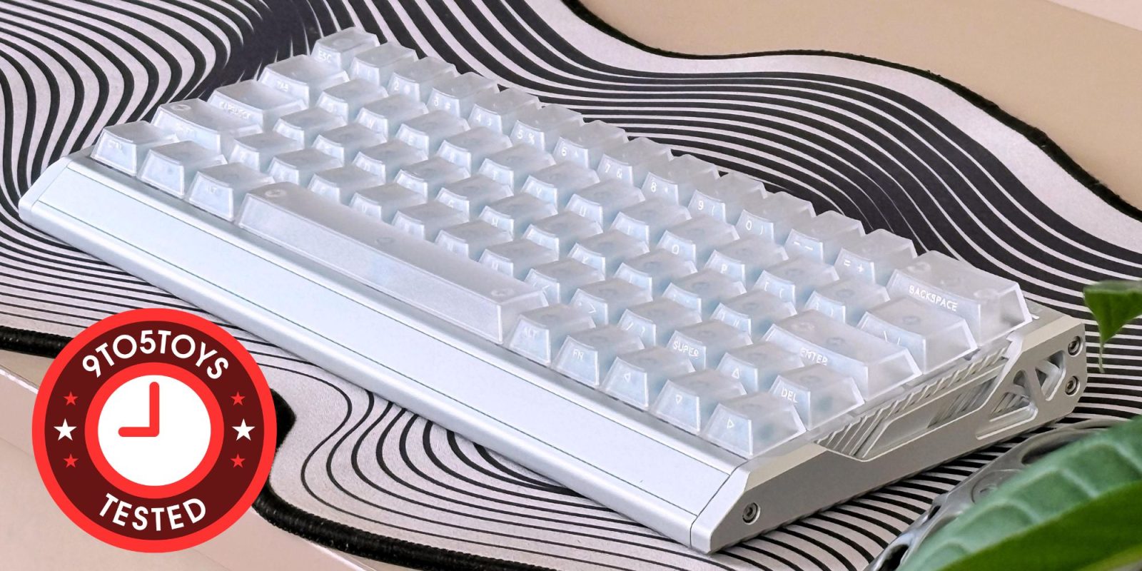 A white keyboard on a black and white striped surface