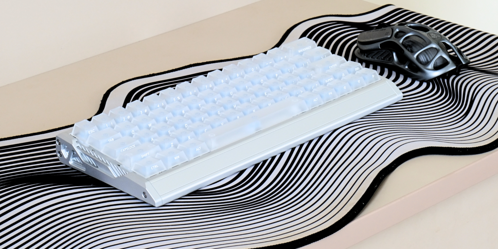 A white keyboard on a black and white striped surface