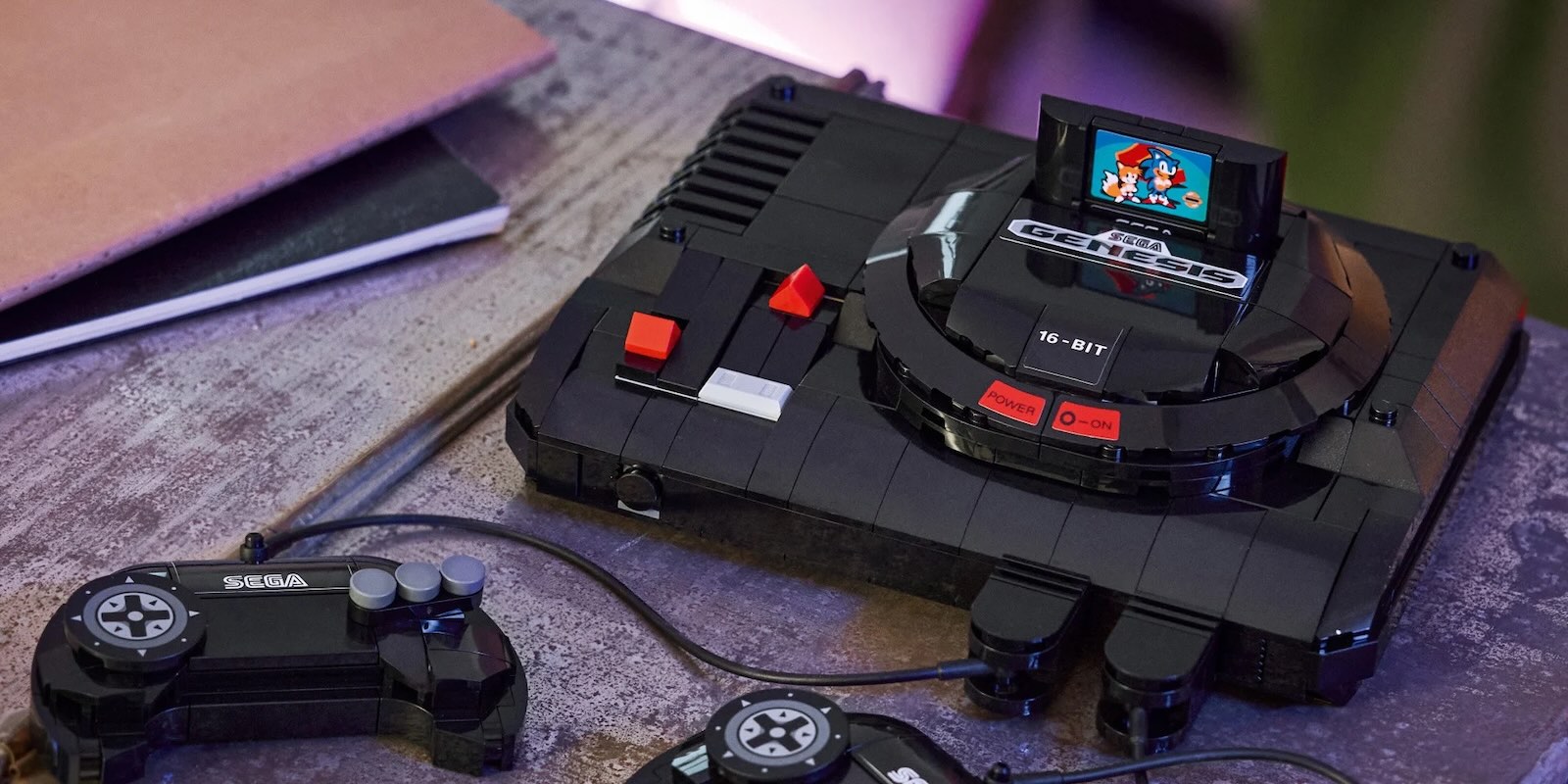 A black gaming console with a video game controller